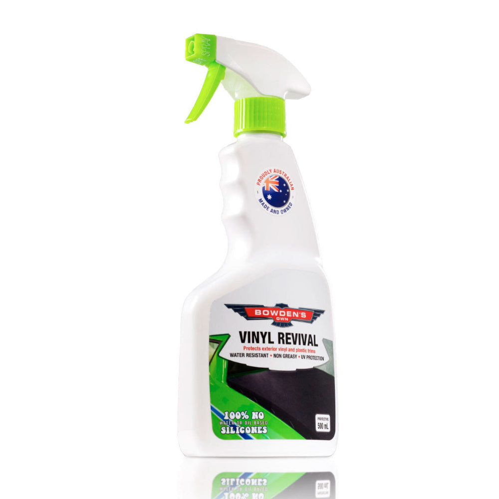 A spray bottle of Bowden's Own Vinyl Revival, primarily white in color with green accents and a label detailing the product name and use.