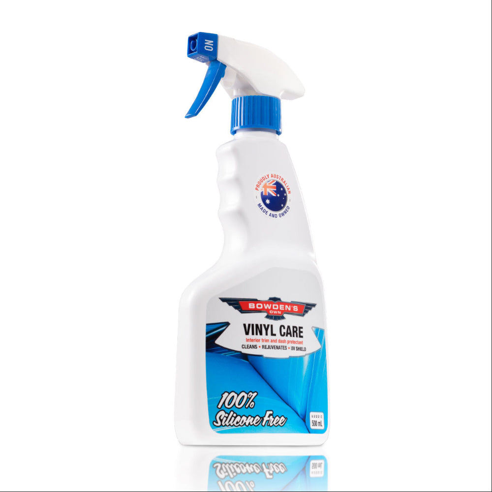 A white spray bottle with a blue label, labeled 'Bowden's Own Vinyl Care', indicating the product is a silicone free interior cleaner and protectant.