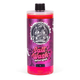 A red bottle of Salty Captain Salt Wash detergent with a label featuring a white cartoon captain character and text indicating the product is a 1L bottle for cleaning boats and vehicles.